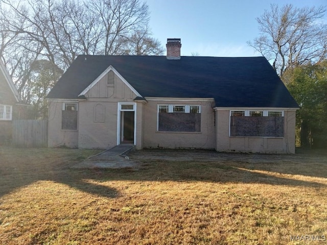 12 E Fairview Ave, Montgomery, AL 36105 - back of house with fence, a chimney, and a yard