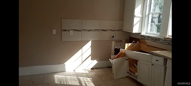 12 E Fairview Ave, Montgomery, AL 36105 - interior space with white cabinets, light countertops, and backsplash