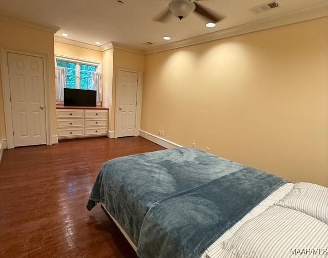 bedroom with dark wood finished floors, baseboards, ornamental molding, visible vents, and recessed lighting