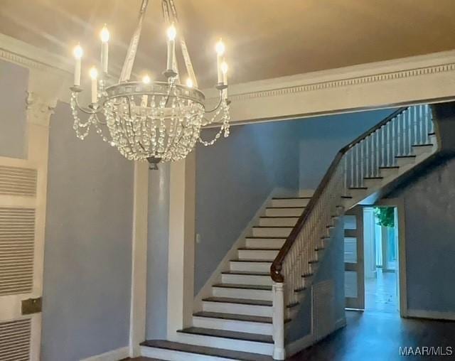 stairs featuring a high ceiling, a chandelier, and baseboards