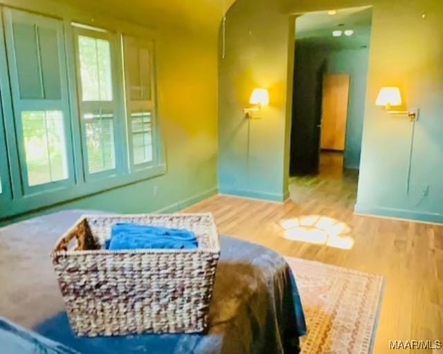 bedroom featuring baseboards and wood finished floors