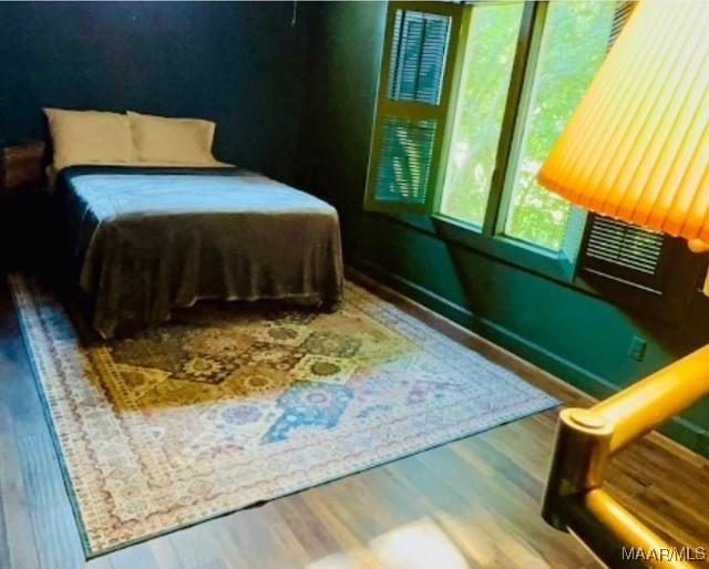 bedroom featuring wood finished floors