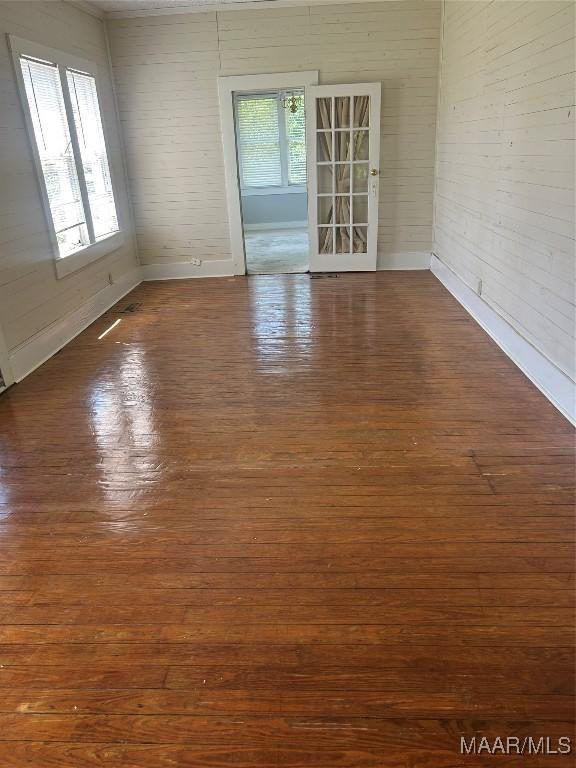 spare room featuring hardwood / wood-style floors and baseboards