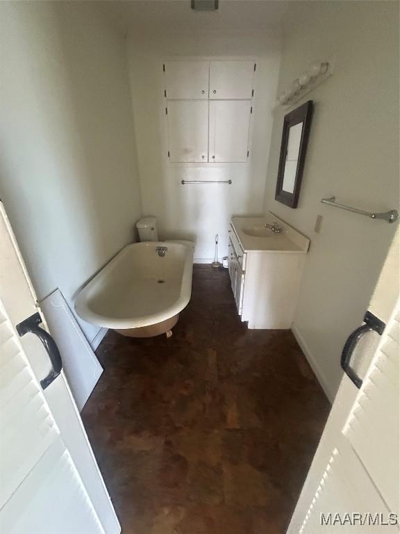 bathroom featuring a freestanding tub and vanity