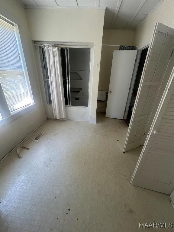 unfurnished bedroom featuring visible vents