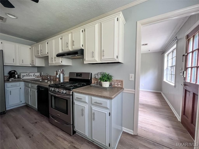 113 Kingston Pl, Prattville, AL 36067 - kitchen featuring black dishwasher, under cabinet range hood, dark wood-style floors, stainless steel gas range, and crown molding