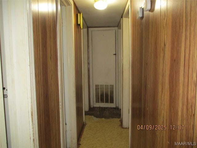 hallway with visible vents and carpet floors