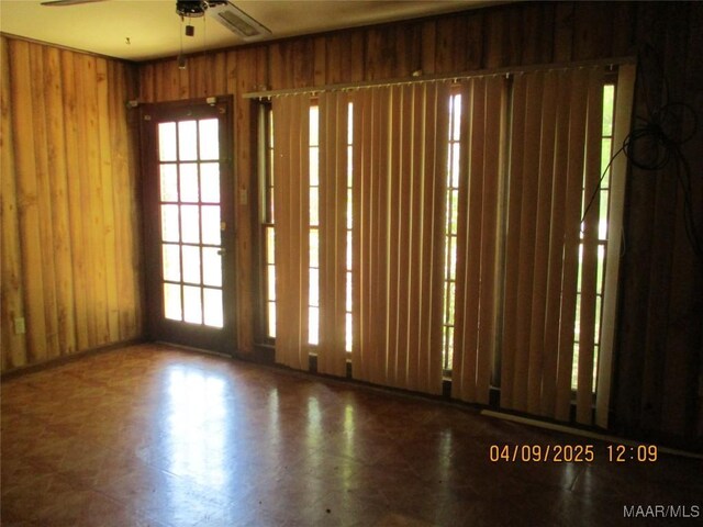 empty room with a wealth of natural light and ceiling fan
