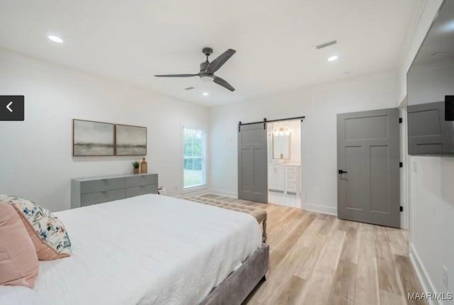 bedroom featuring light wood finished floors, recessed lighting, a barn door, ceiling fan, and crown molding