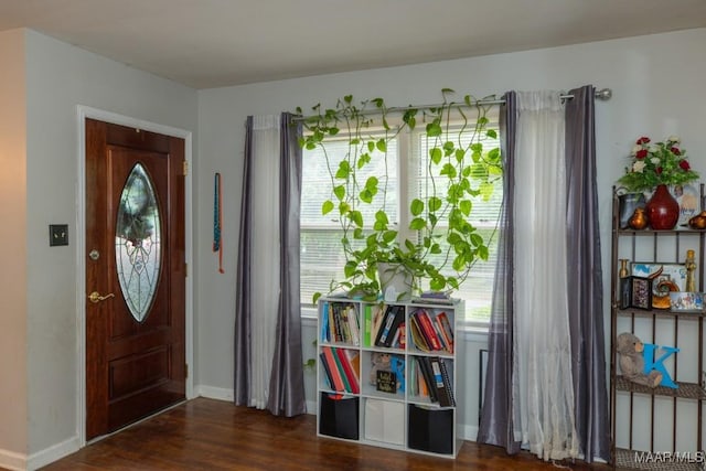 foyer with wood finished floors and baseboards