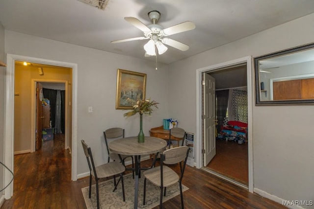 dining space featuring baseboards, wood finished floors, and ceiling fan