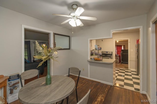 dining area featuring a ceiling fan, hardwood / wood-style flooring, and baseboards