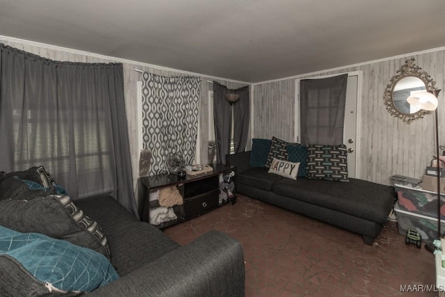 living room with wooden walls, ornamental molding, and carpet floors