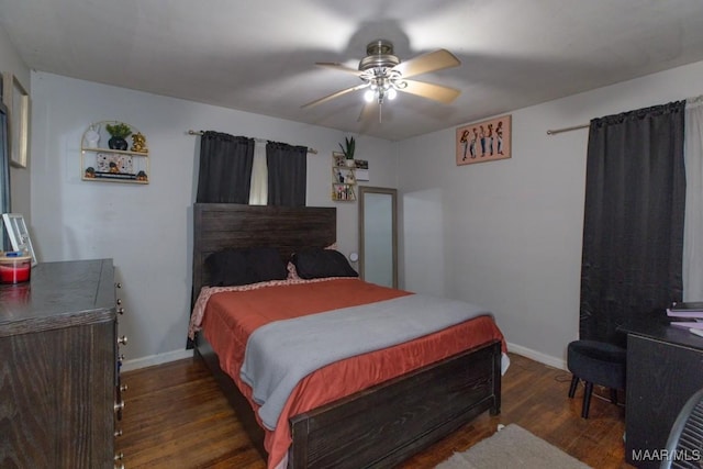 bedroom featuring ceiling fan, wood finished floors, and baseboards
