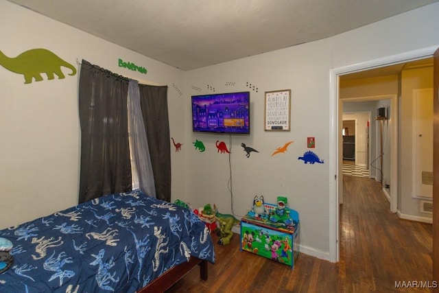 bedroom featuring wood finished floors and baseboards