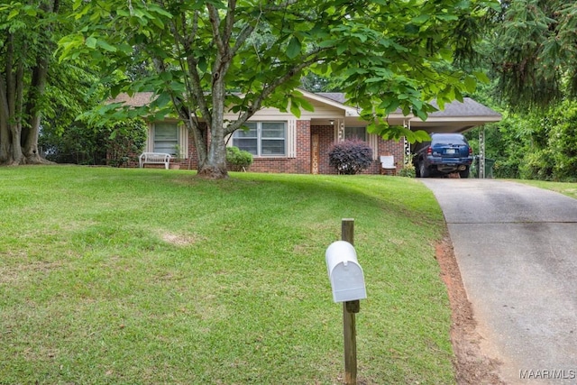 obstructed view of property with a front lawn, driveway, an attached carport, and brick siding