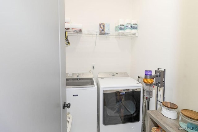clothes washing area featuring laundry area and washing machine and dryer