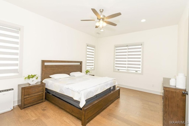 bedroom with baseboards, recessed lighting, ceiling fan, and light wood-style flooring