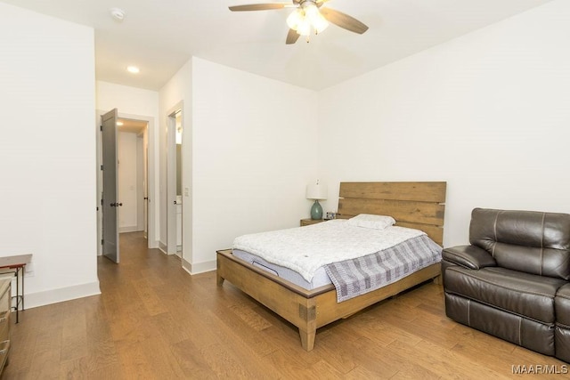bedroom with baseboards, recessed lighting, wood finished floors, and a ceiling fan