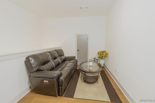 sitting room with visible vents, baseboards, and light wood-style floors
