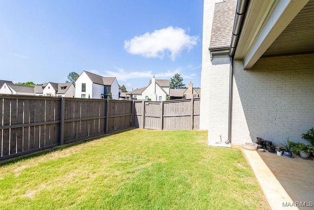 view of yard with a residential view and a fenced backyard