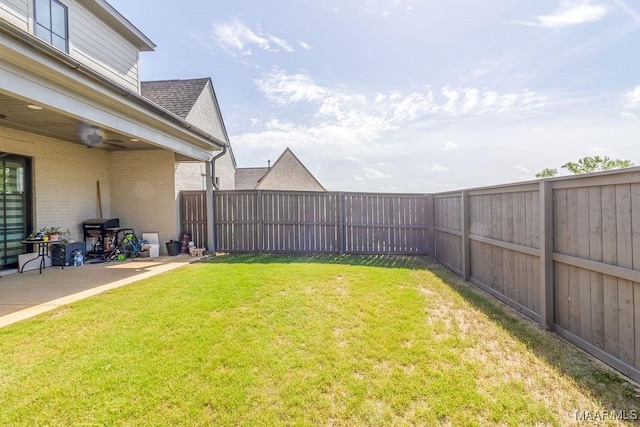 view of yard with a patio and a fenced backyard
