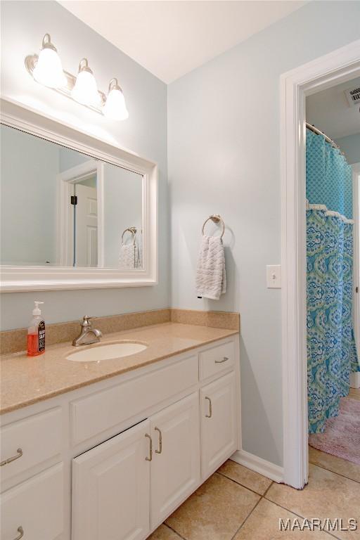 bathroom with vanity, visible vents, and tile patterned floors