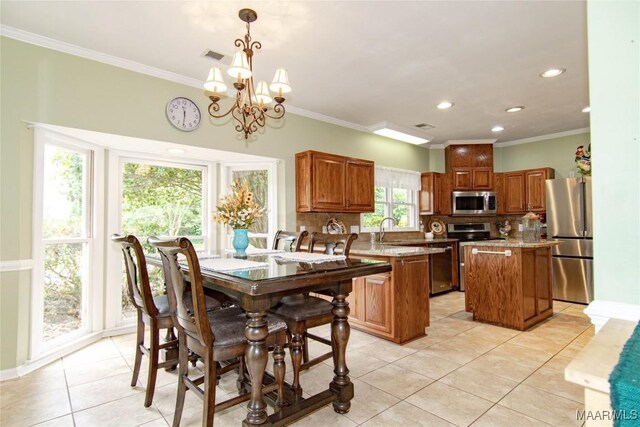 dining space with light tile patterned floors, visible vents, recessed lighting, ornamental molding, and a notable chandelier