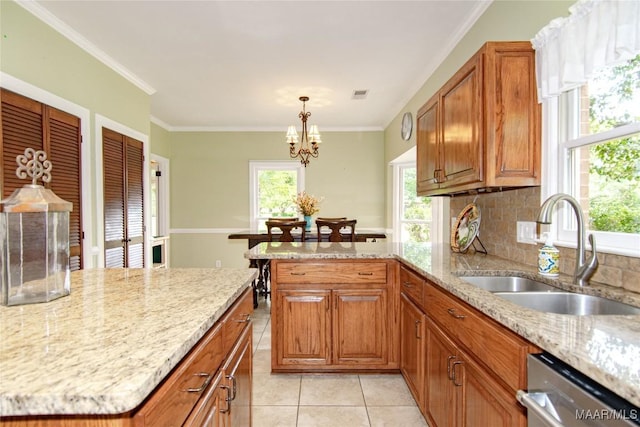 kitchen featuring light tile patterned floors, dishwasher, a sink, and a healthy amount of sunlight