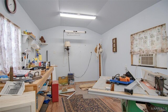 miscellaneous room with lofted ceiling, wood finished floors, and cooling unit