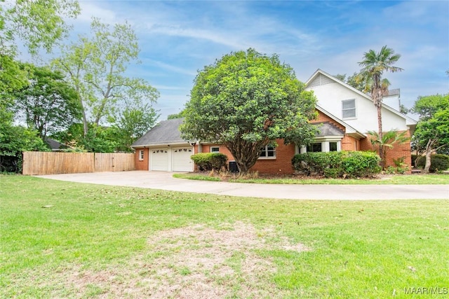 view of front of property with a front yard, a garage, brick siding, concrete driveway, and fence