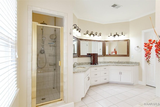 full bath featuring a sink, visible vents, a stall shower, ornamental molding, and tile patterned flooring