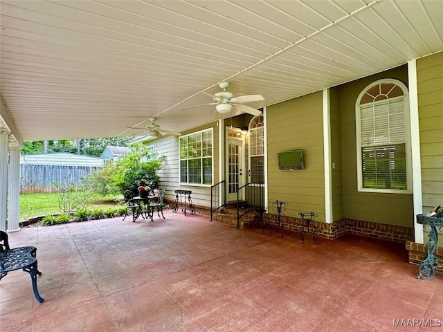 view of patio / terrace with ceiling fan and fence