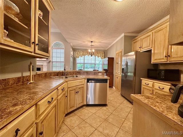 kitchen featuring a sink, an inviting chandelier, glass insert cabinets, a peninsula, and appliances with stainless steel finishes
