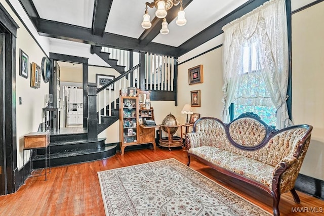 48 S Capitol Pkwy, Montgomery, AL 36107 - living area featuring beam ceiling, stairway, wood finished floors, and an inviting chandelier