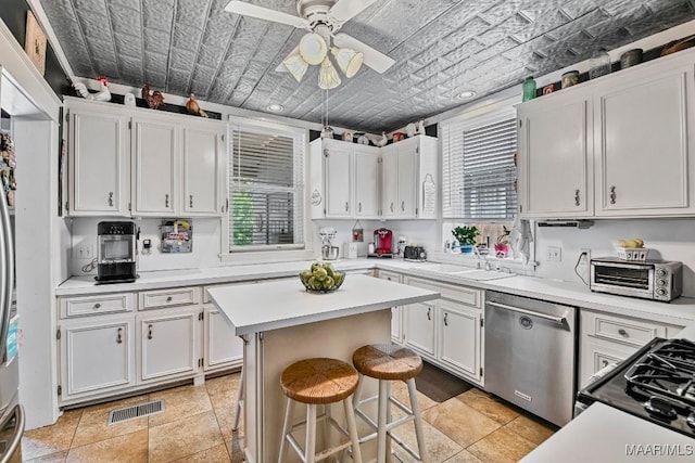 48 S Capitol Pkwy, Montgomery, AL 36107 - kitchen with an ornate ceiling, a toaster, visible vents, white cabinetry, and stainless steel dishwasher