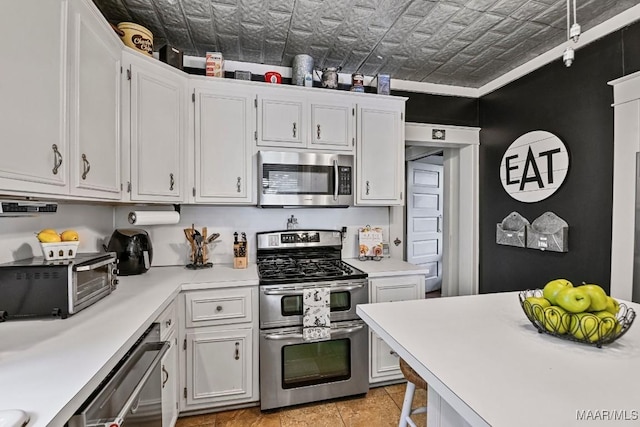 48 S Capitol Pkwy, Montgomery, AL 36107 - kitchen featuring an ornate ceiling, stainless steel appliances, light countertops, and white cabinets
