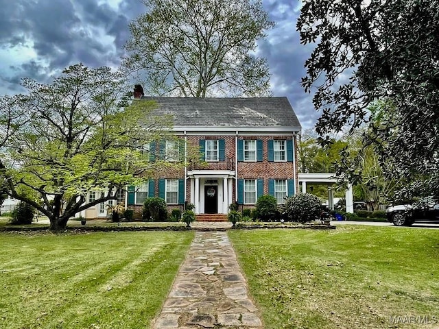 100 S Franklin Ave, Luverne, AL 36049 - view of front of property with brick siding, a chimney, and a front lawn