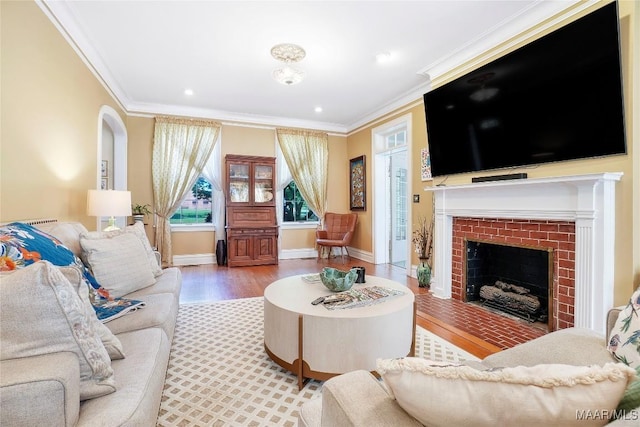 100 S Franklin Ave, Luverne, AL 36049 - living area with crown molding, baseboards, a brick fireplace, and wood finished floors