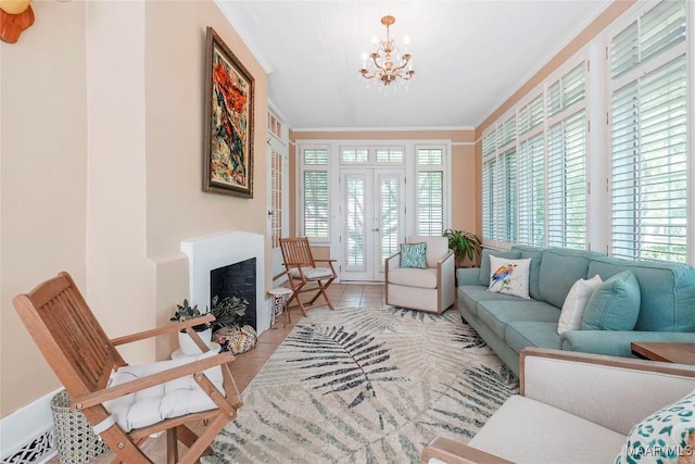 100 S Franklin Ave, Luverne, AL 36049 - tiled living area with an inviting chandelier, crown molding, a fireplace, and french doors