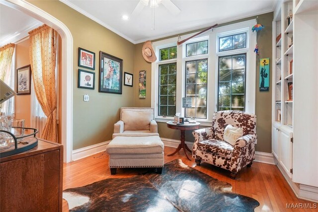 100 S Franklin Ave, Luverne, AL 36049 - sitting room with crown molding, arched walkways, a ceiling fan, and hardwood / wood-style floors