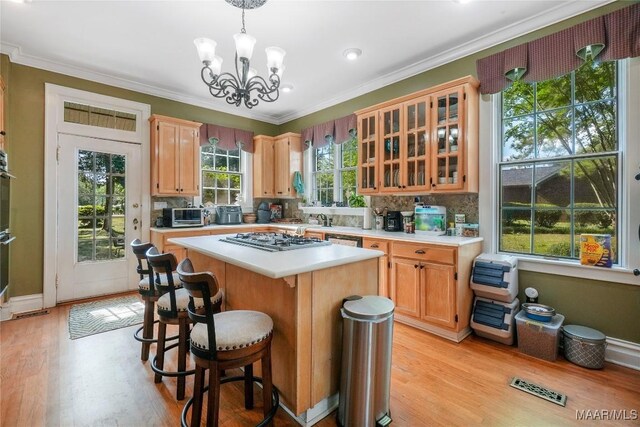 100 S Franklin Ave, Luverne, AL 36049 - kitchen featuring stainless steel gas stovetop, light countertops, a center island, and a notable chandelier