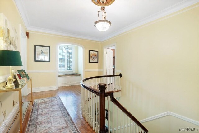 100 S Franklin Ave, Luverne, AL 36049 - hall with ornamental molding, wood finished floors, baseboards, arched walkways, and an upstairs landing
