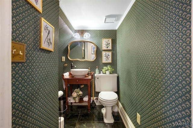 100 S Franklin Ave, Luverne, AL 36049 - bathroom featuring toilet, ornamental molding, a sink, and marble finish floor