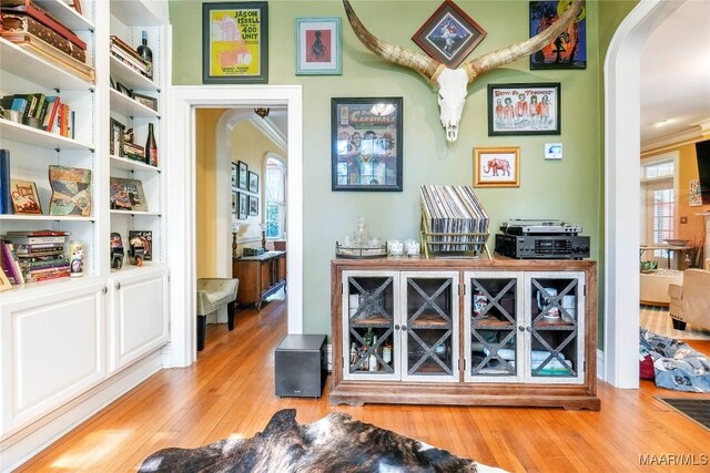 100 S Franklin Ave, Luverne, AL 36049 - bar with arched walkways, ornamental molding, and wood finished floors