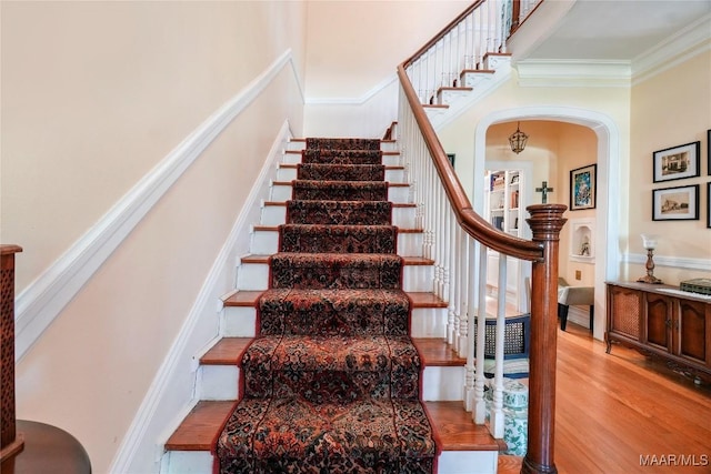 100 S Franklin Ave, Luverne, AL 36049 - stairway featuring crown molding, arched walkways, wood finished floors, and a towering ceiling