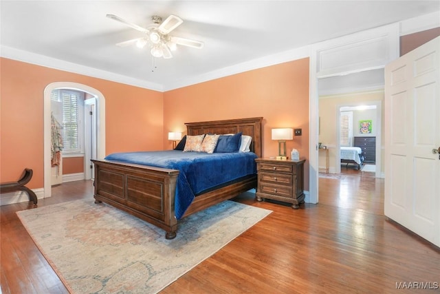 100 S Franklin Ave, Luverne, AL 36049 - bedroom featuring baseboards, arched walkways, ceiling fan, and wood finished floors
