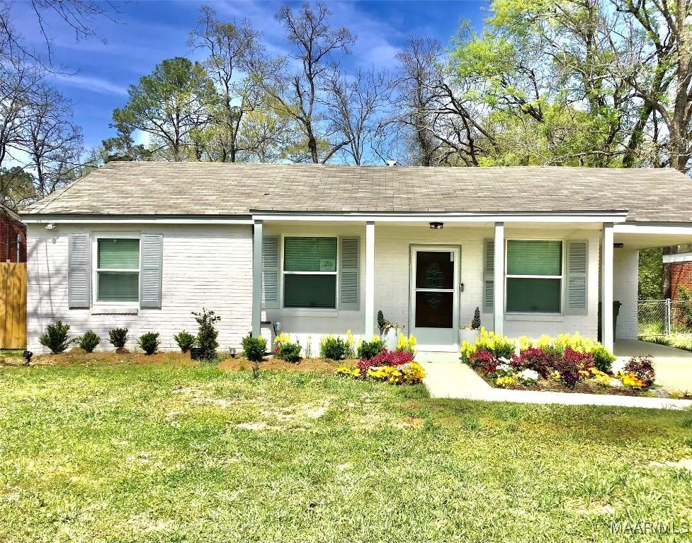 644 Iris Ln, Montgomery, AL 36105 - single story home with a front yard, a carport, fence, and roof with shingles