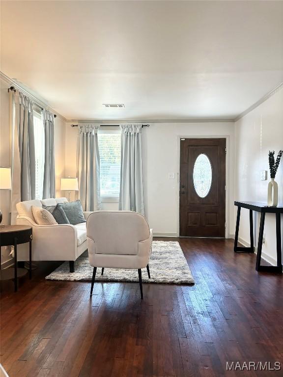 644 Iris Ln, Montgomery, AL 36105 - living area featuring plenty of natural light, dark wood-type flooring, ornamental molding, and baseboards