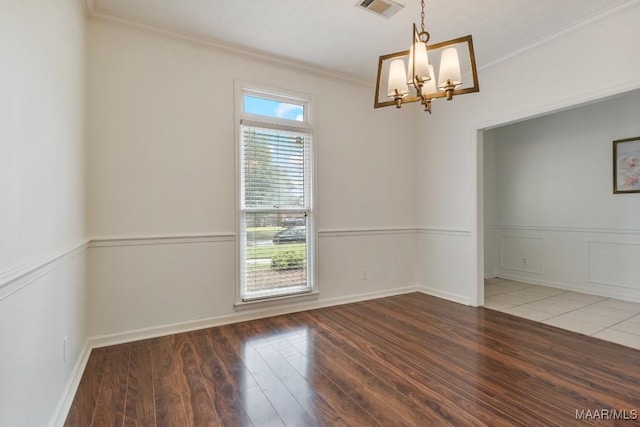 unfurnished room with ornamental molding, visible vents, a chandelier, and wood-type flooring